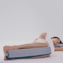 Person lying on their side with the Orthex Symbia 03 knee cushion between knees and ankles