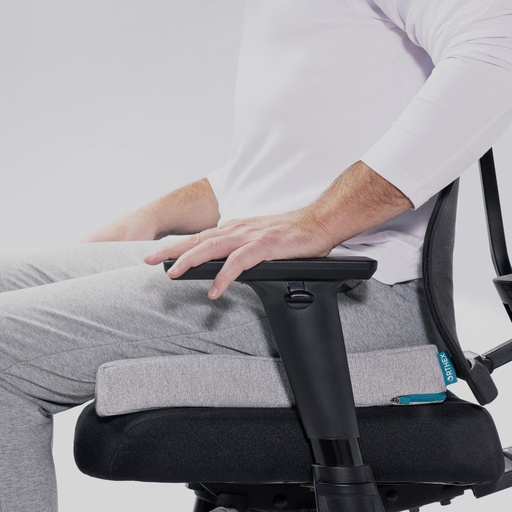 Person seated on the Orthex Symbia 2.5 seat cushion in an office chair
