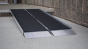 EZ-ACCESS SUITCASE Singlefold AS ramp lying open on a walk at a block wall