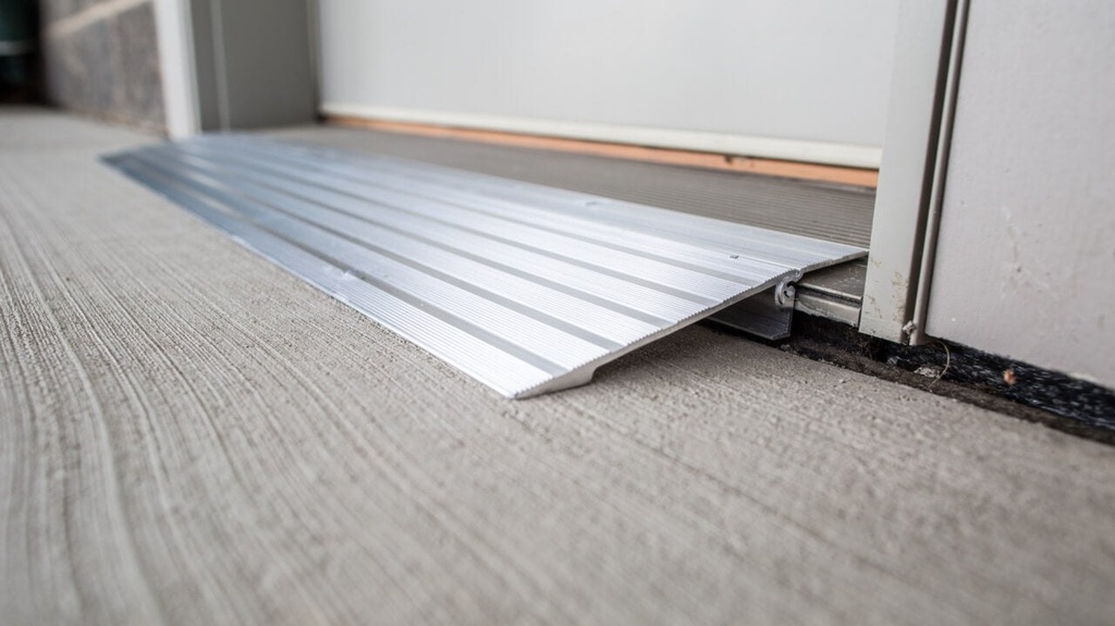 Close view of the TRANSITIONS aluminum ramp edge against a threshold