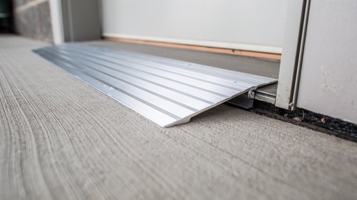 Close view of the TRANSITIONS aluminum ramp edge against a threshold