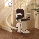 Handicare Freecurve stairlift on its curved rail at the foot of a staircase