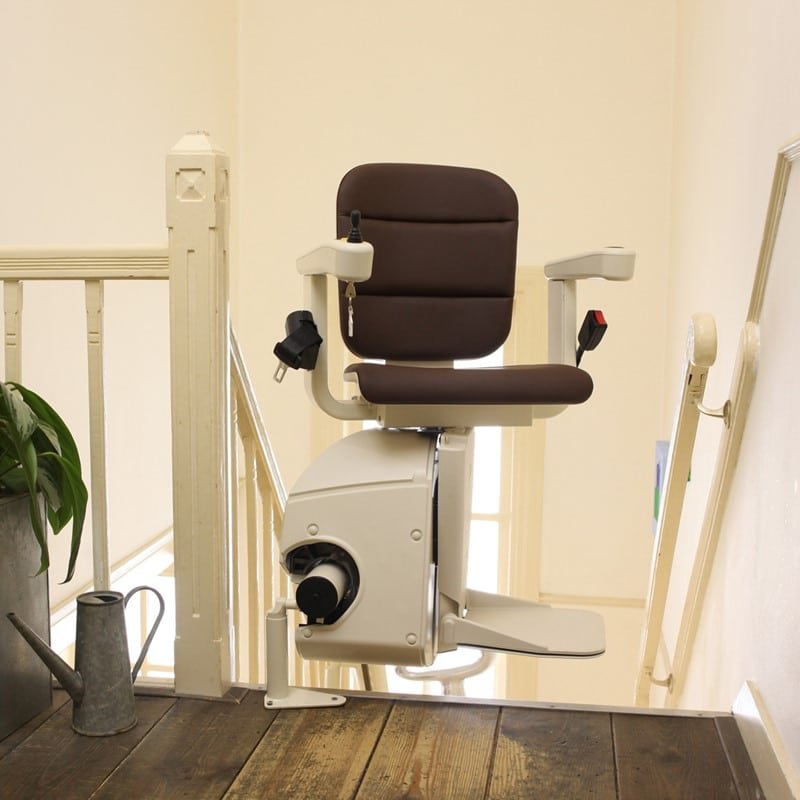 Freecurve chair parked at the top of a staircase beside its curved rail