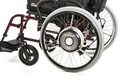 Quickie Xtender motorised rear wheel unit seen close up, showing the hub motor on the wheel
