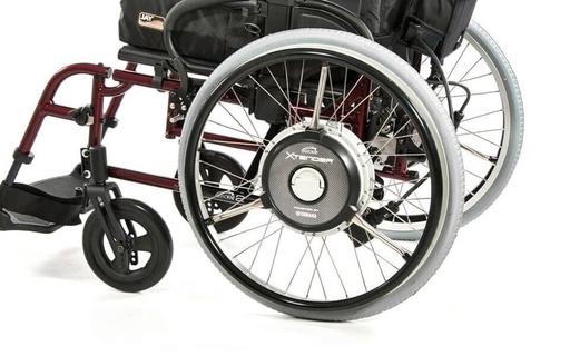 Quickie Xtender motorised rear wheel unit seen close up, showing the hub motor on the wheel