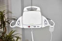 M-Series Portable ceiling lift hanging from a track in a room, with the hand control attached