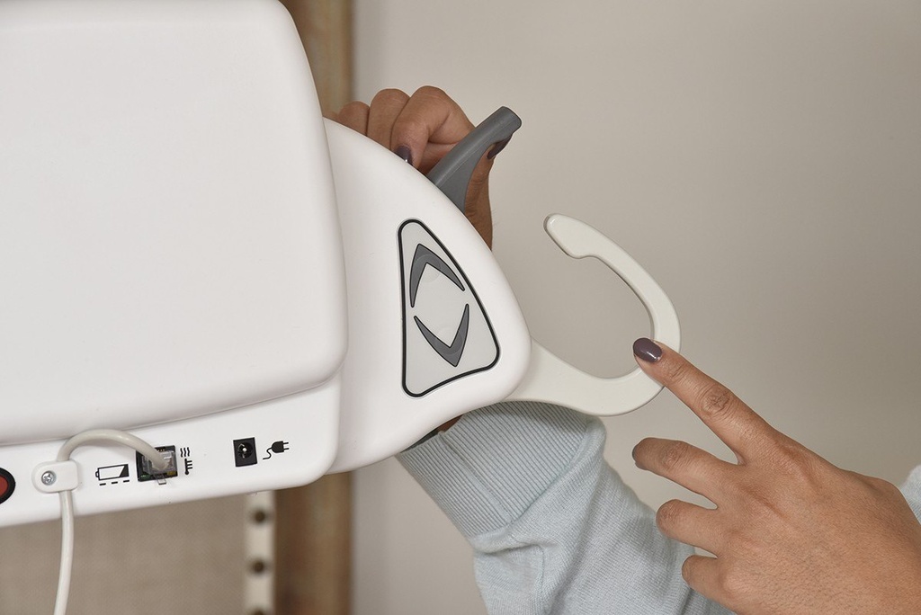 A hand sliding a sling loop into the SureClip hook on the portable lift