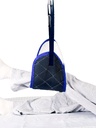 Quilted band sling lifting a lower leg, with blue trim and a white backing