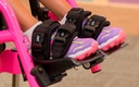 JAY shoe holders strapped over a child's shoes on wheelchair footplates
