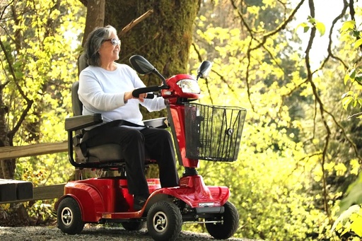 Fortress S410 in red with its front basket, shown from the side on a paved path