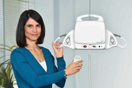 The Monarch portable ceiling lift on its track, with a carer holding the hand control