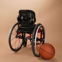 Ride Designs Java Decaf back on a pediatric wheelchair beside a basketball