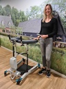 Person standing beside a Bure Double 2.0 and holding its coiled hand control