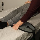 Folded quilted band slid under the knee before the strap is pulled through