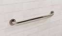 Polished chrome grab bar mounted level on white wall tile