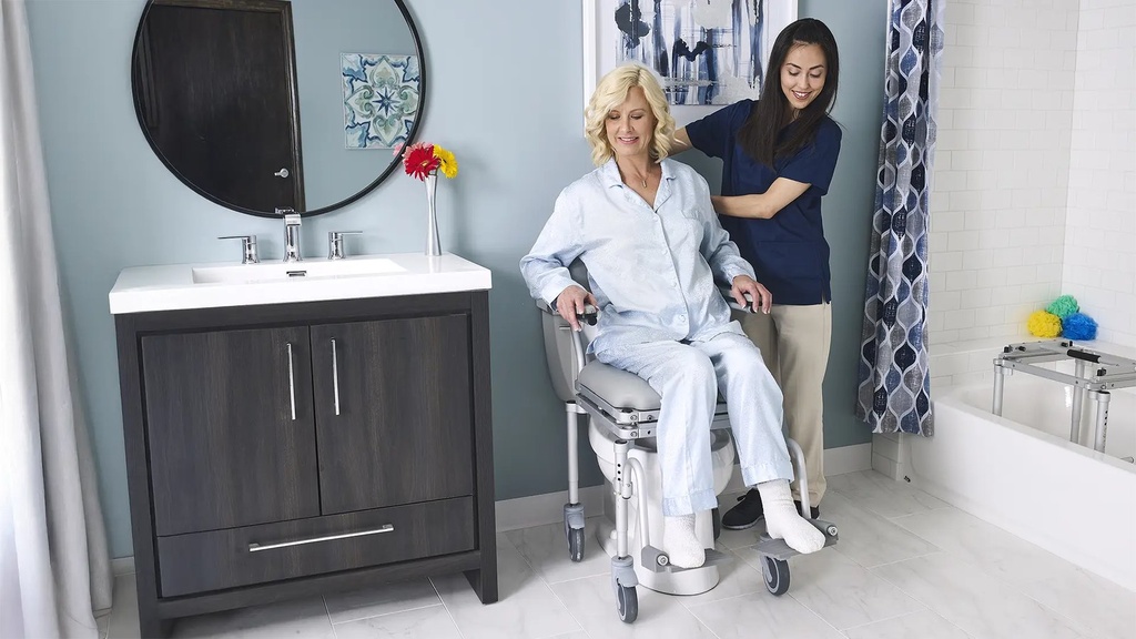 MC6000 roll-in chair over a toilet, with the tub frame standing beside the bathtub