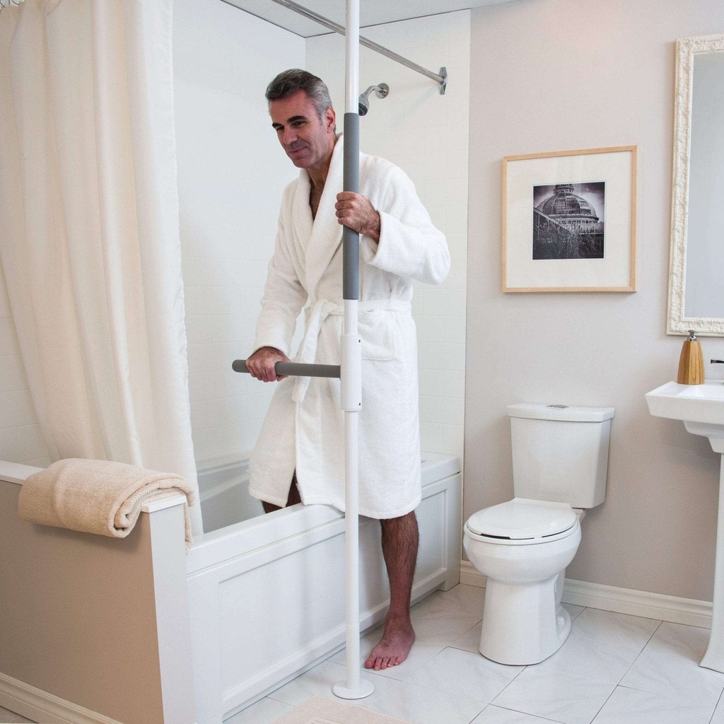 Man in a bathrobe stepping out of the bathtub while holding the pole and the SuperBar