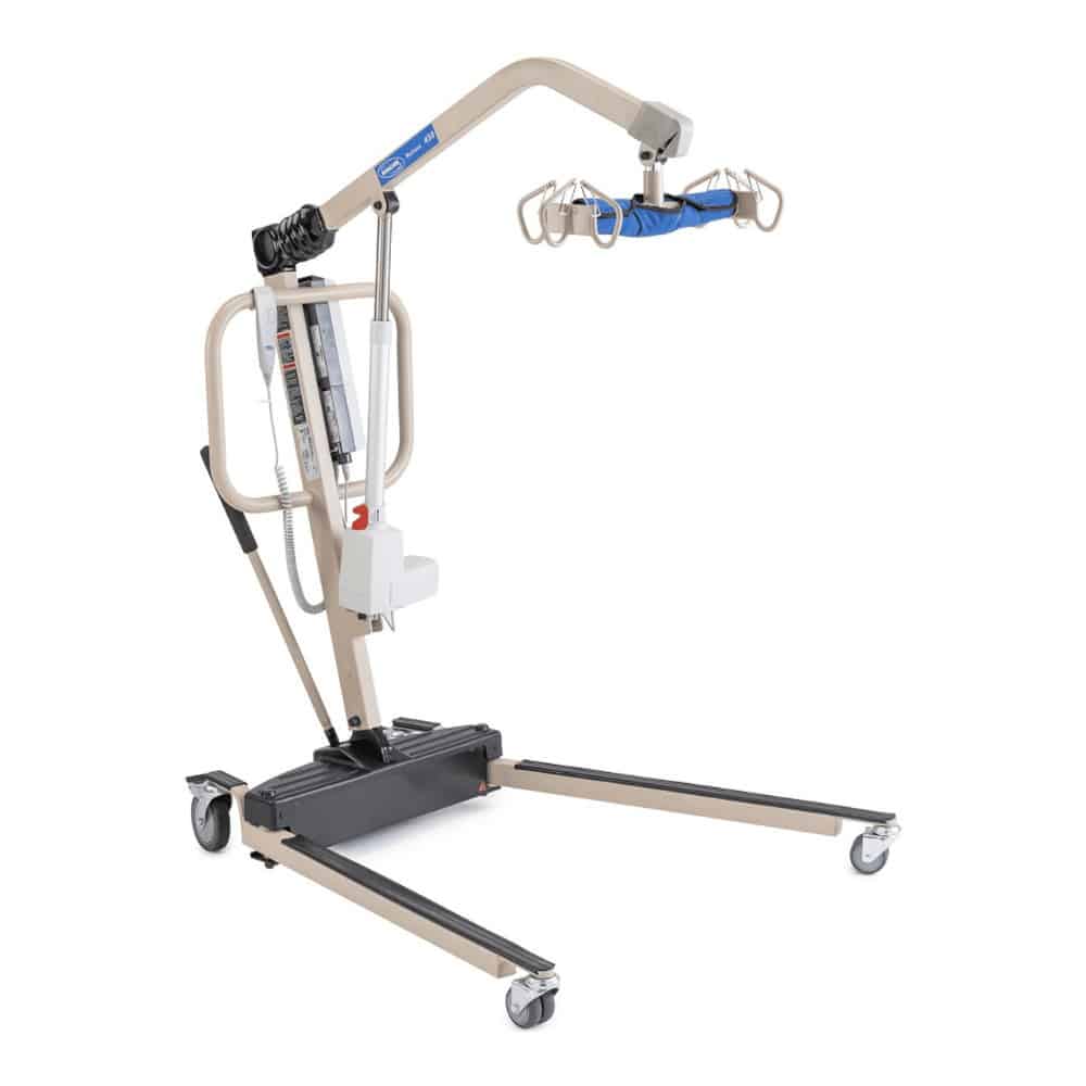 Example battery-powered floor lift with a beige frame, hand control and a spreader bar with six hooks