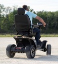 Rear view of the Baja Wrangler 2 on a gravel path, showing the seat back, tail lights and wide rear tires